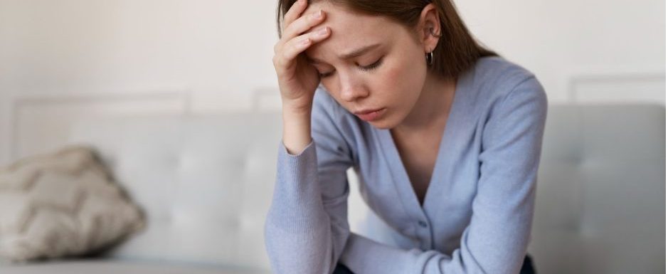 жена с тревожност седи на диван